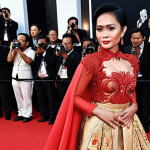 **Image of a popular Indonesian actress on the red carpet at a film premiere, wearing a unique and stylish outfit, showcasing her influence on fashion.** (Focus: Fashion, red carpet, Indonesian celebrity)